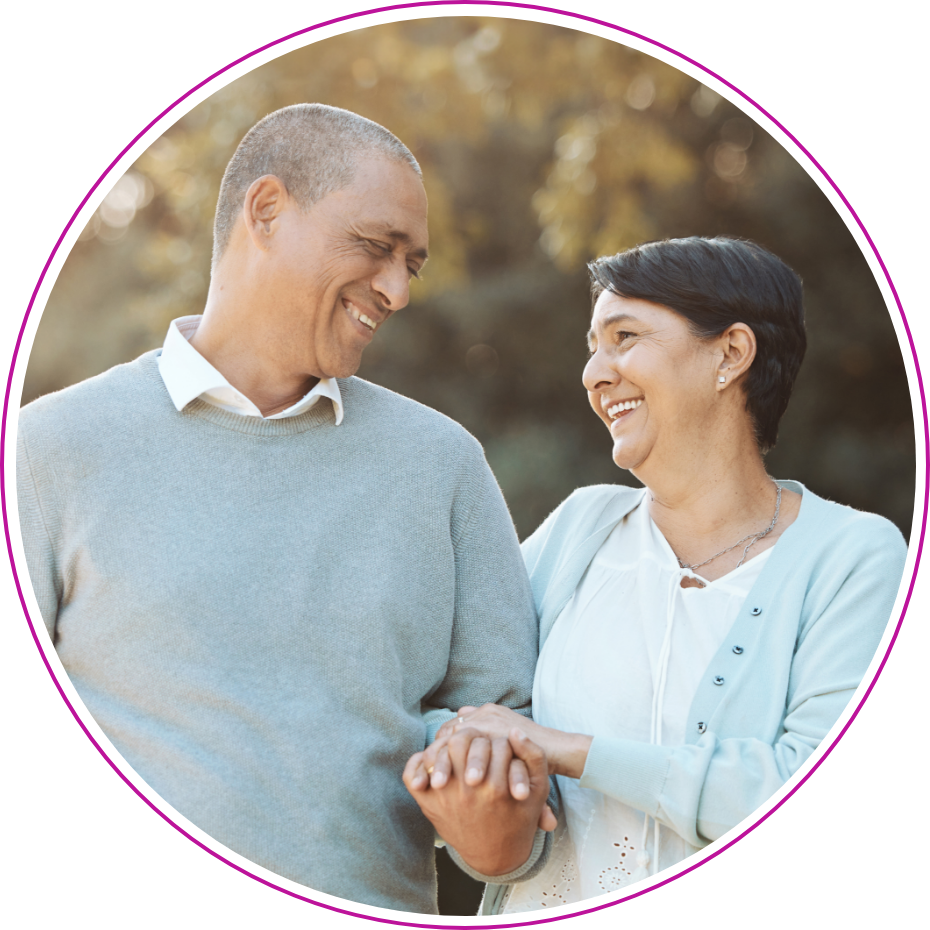 A man and woman holding hands smiling at one another