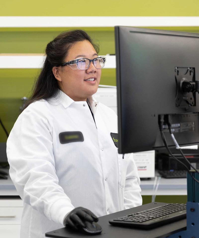 A clinician working at a computer in a Freenome lab